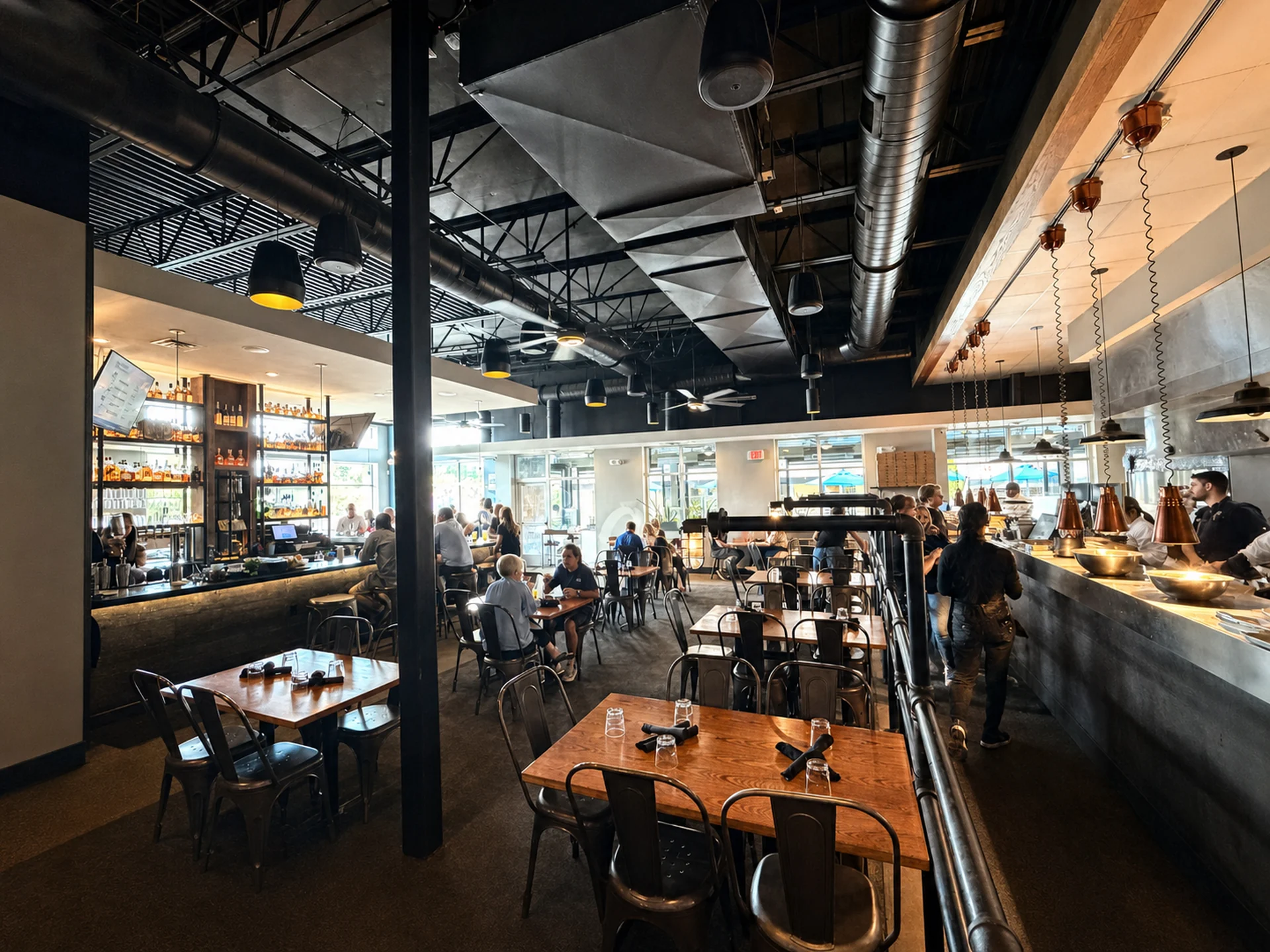 A wide view across the Charred bar, dining room and open kitchen pass