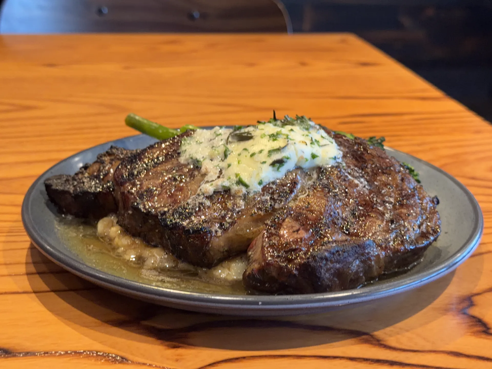 Bone-in Angus steak finished with herb butter