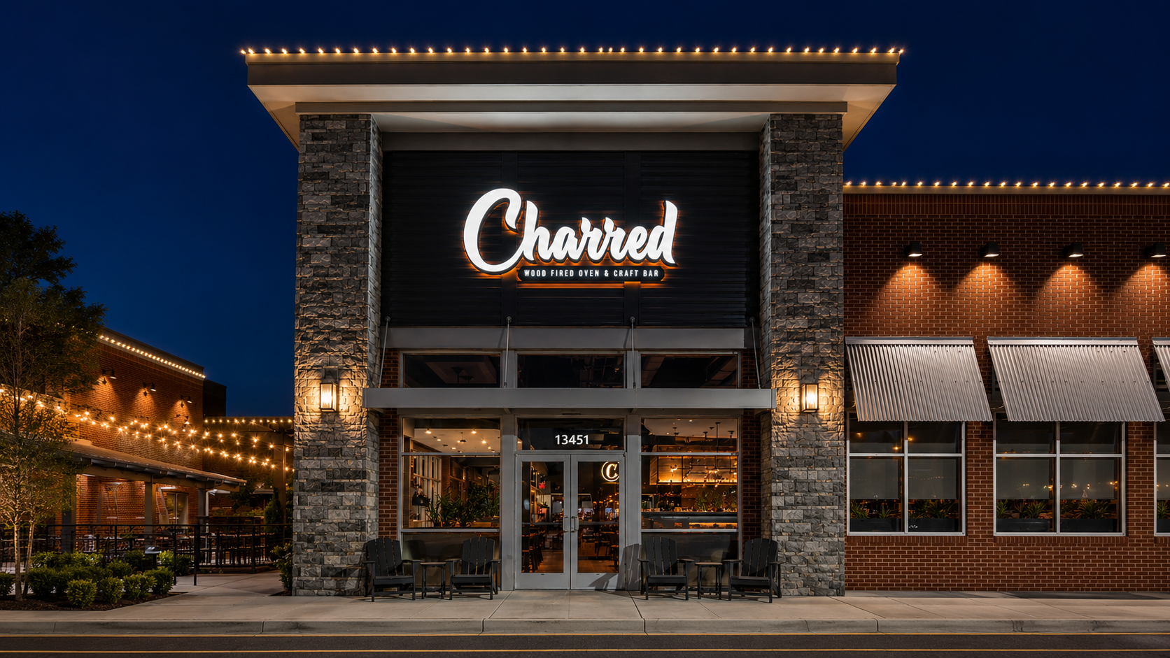 The illuminated front entrance of Charred Swift Creek at night