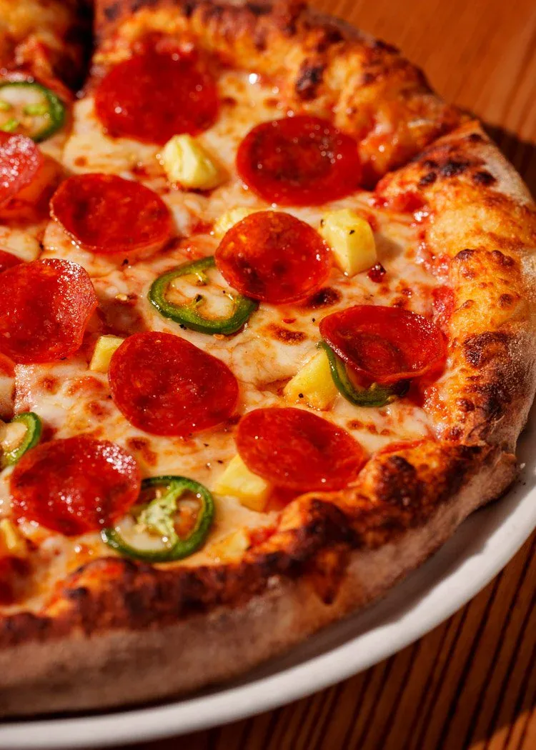 Hot Hawaiian pizza with pepperoni, jalapeño, and pineapple