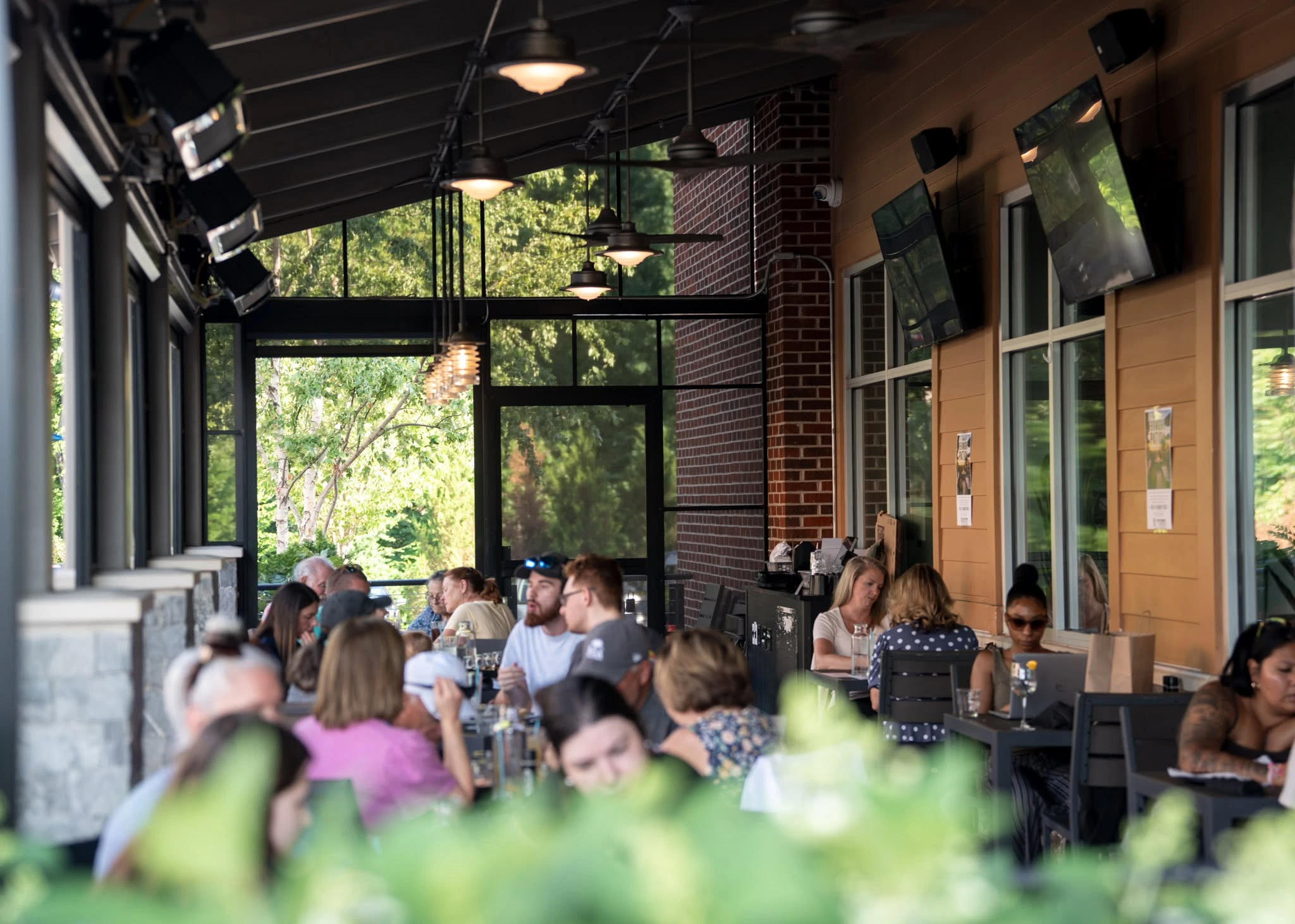 The covered Charred patio filled with guests at dinner