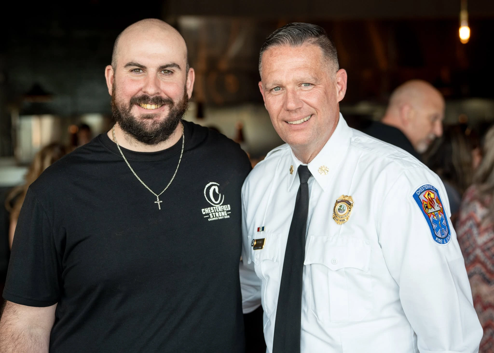 A Charred team member standing with a Chesterfield County public safety leader