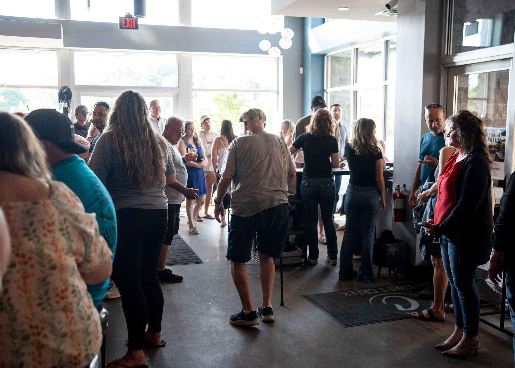 Guests and Charred team members gathering near the restaurant entrance during a community event