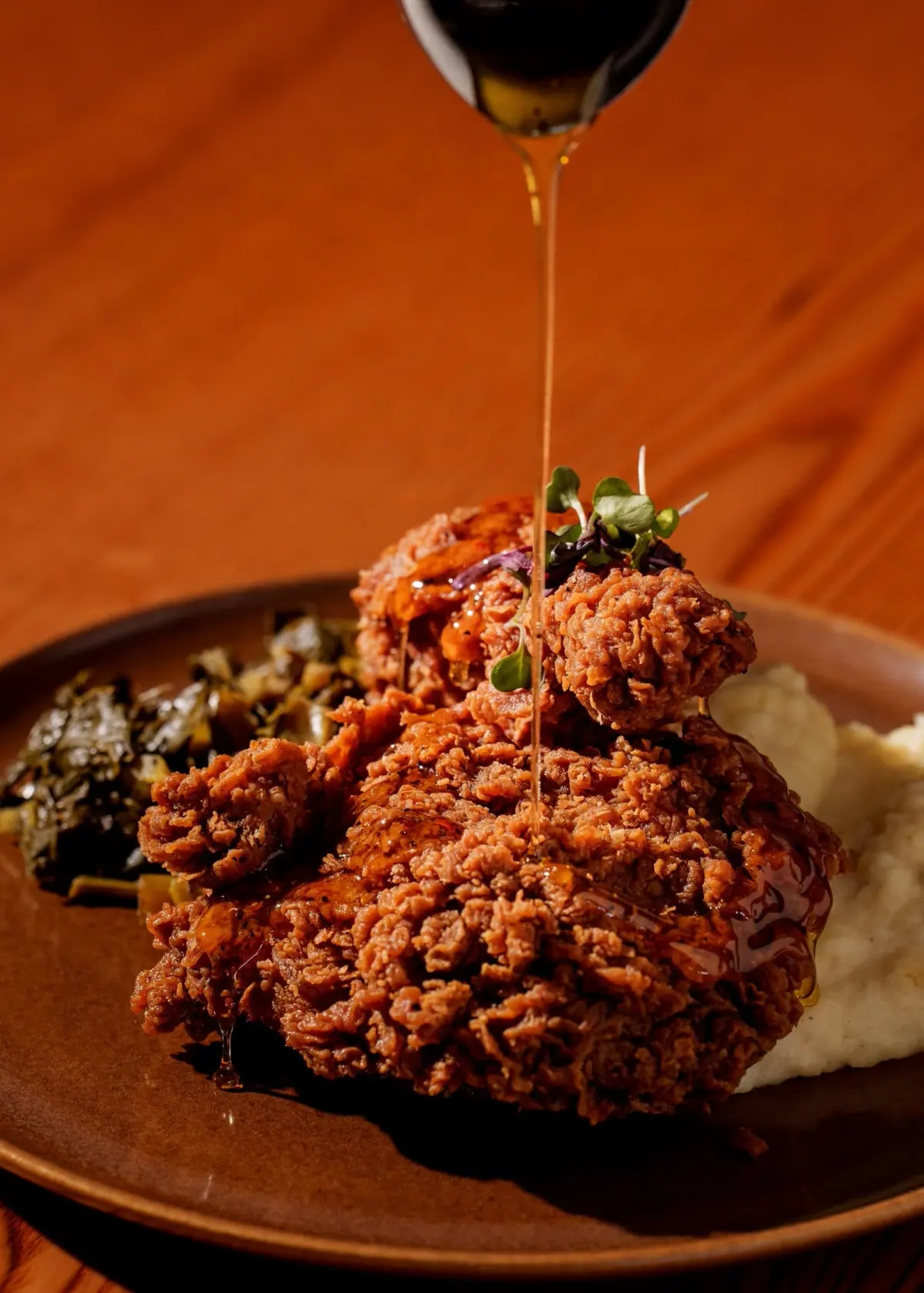 Crisp fried chicken stacked over mashed potatoes in the dining room